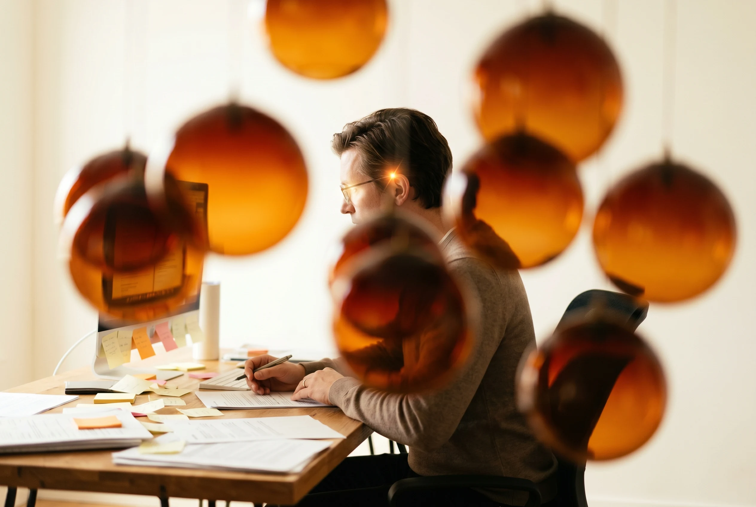 An operator mid-thought at a desk, intelligence scattered across separate vendor accounts.